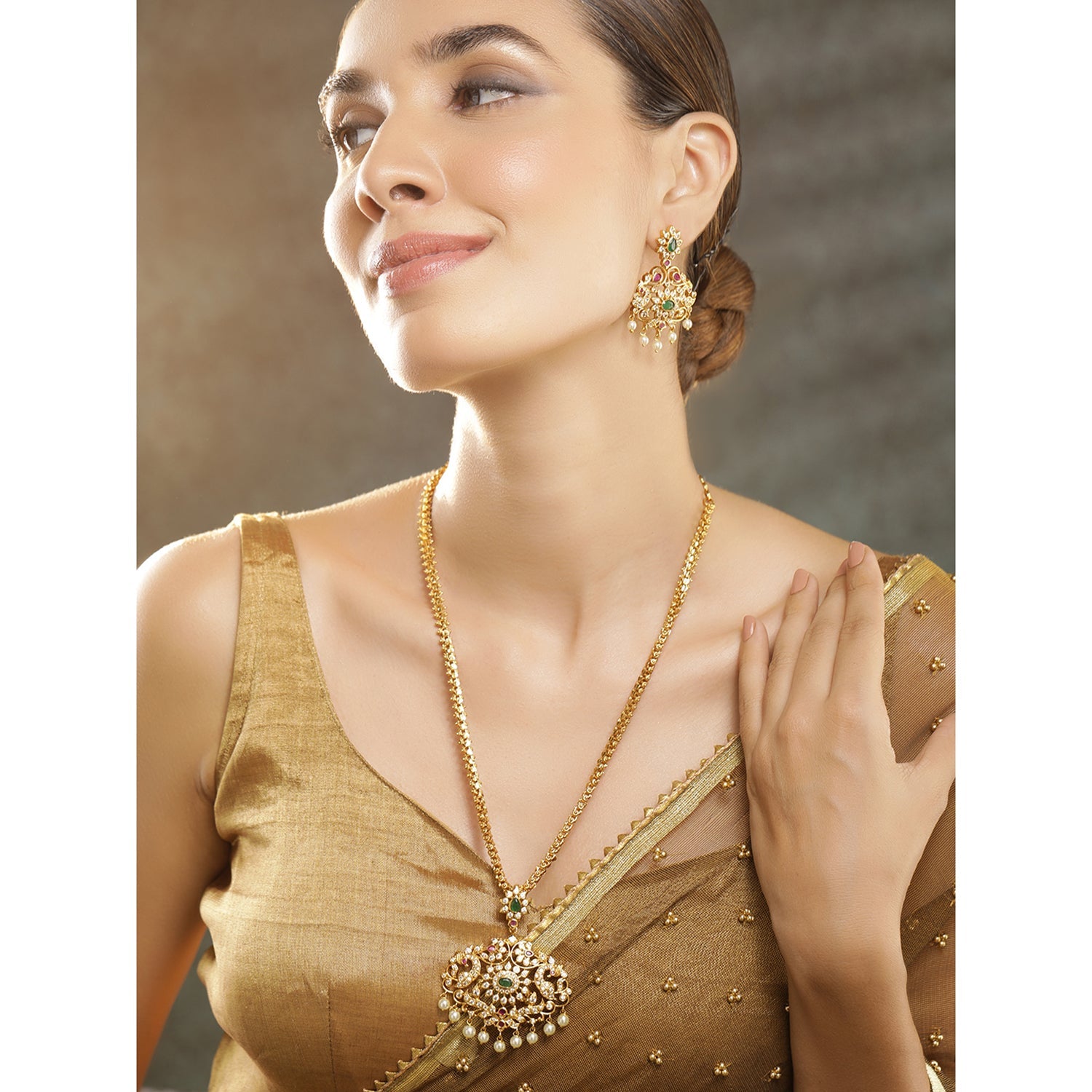 Wentra Women Gold-Plated Emerald Green & Cubic Zirconia Stone Studded Temple Jewellery Set