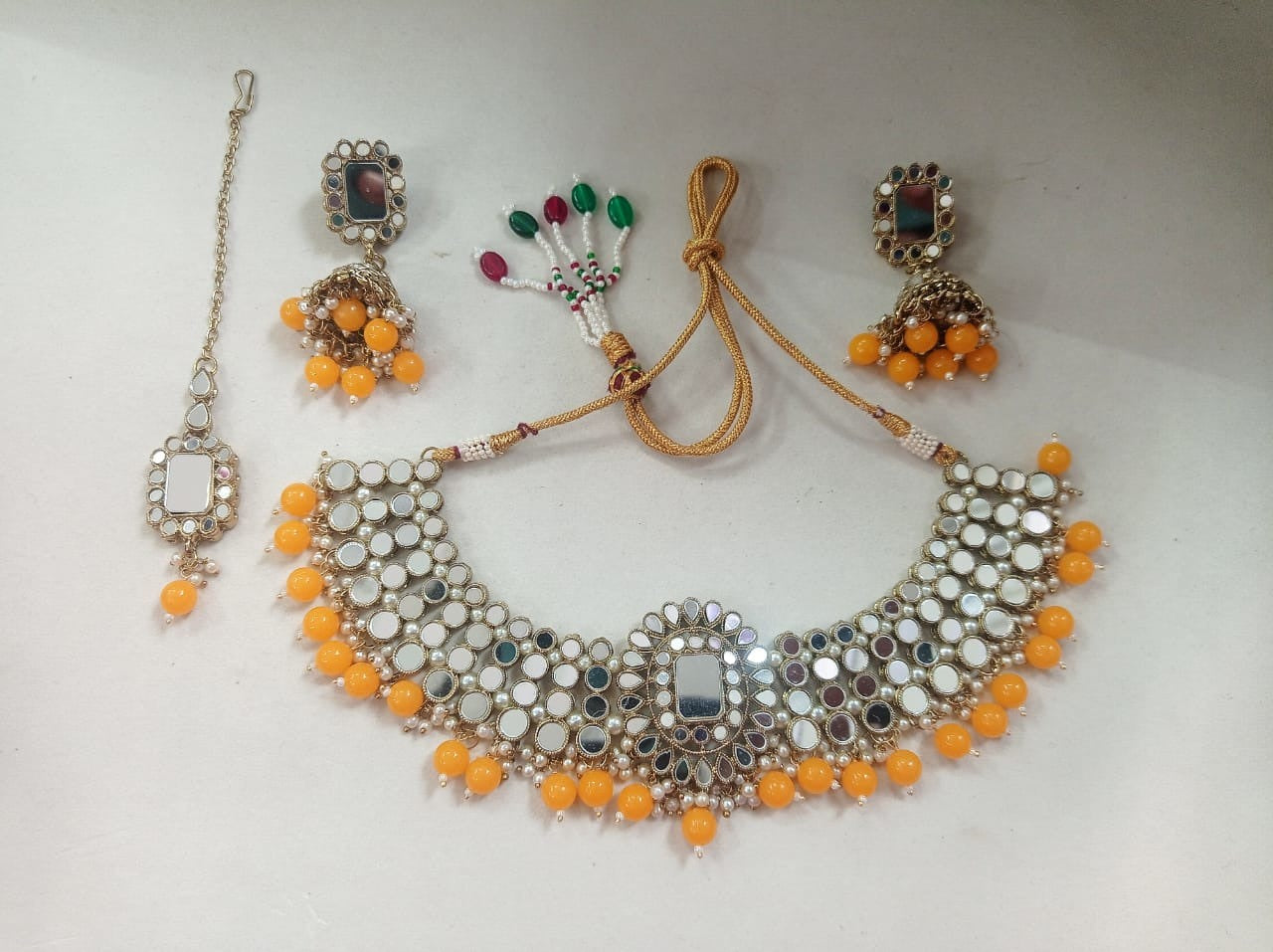 Wentra Gold Plated Mirror Studded Yellow Beads Necklace Set.
