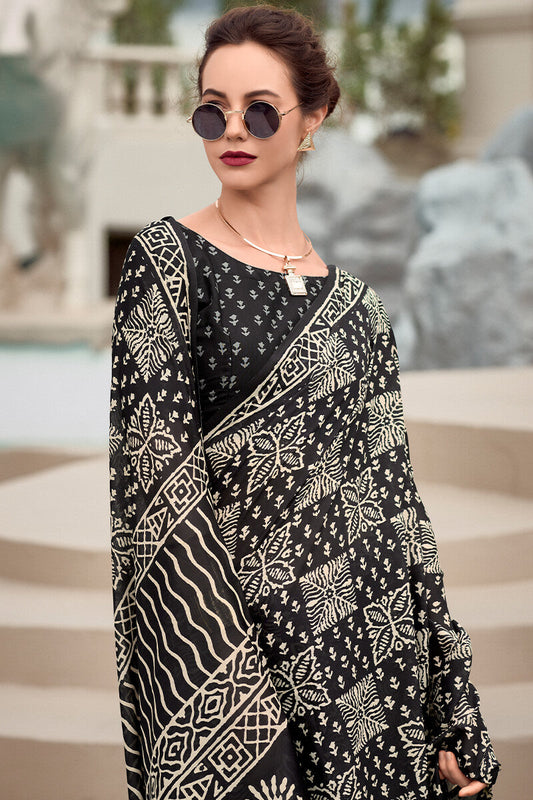 Cynosure Black Printed Mul Cotton Saree With Beleaguer Blouse Piece