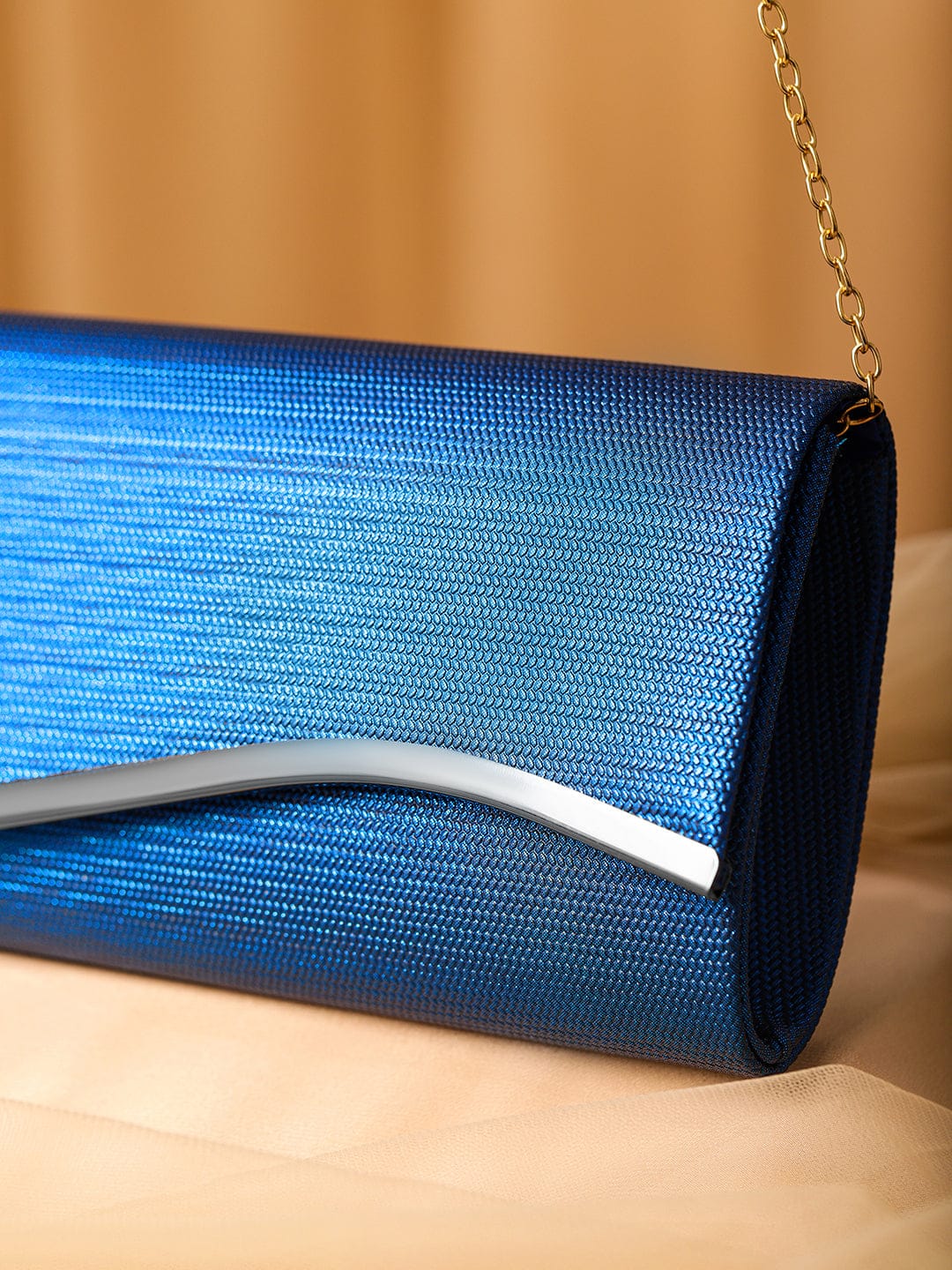 Wentra Blue Sapphire Glossy Textured Clutch with Silver-Tone Wavy Accent & Chain