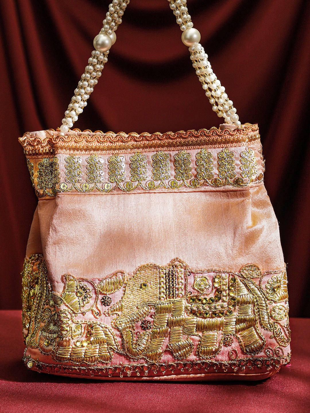 Wentra Handcrafted Peach Pink Silk Potli Bag with Pearl Handle & Gold Embroidered Elephant Motif