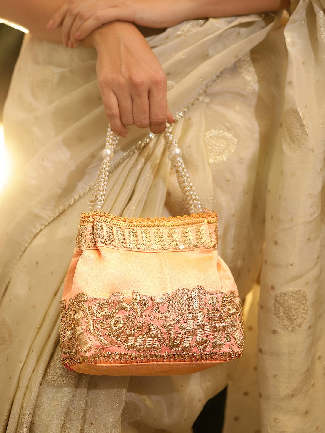 Wentra Handcrafted Peach Pink Silk Potli Bag with Pearl Handle & Gold Embroidered Elephant Motif