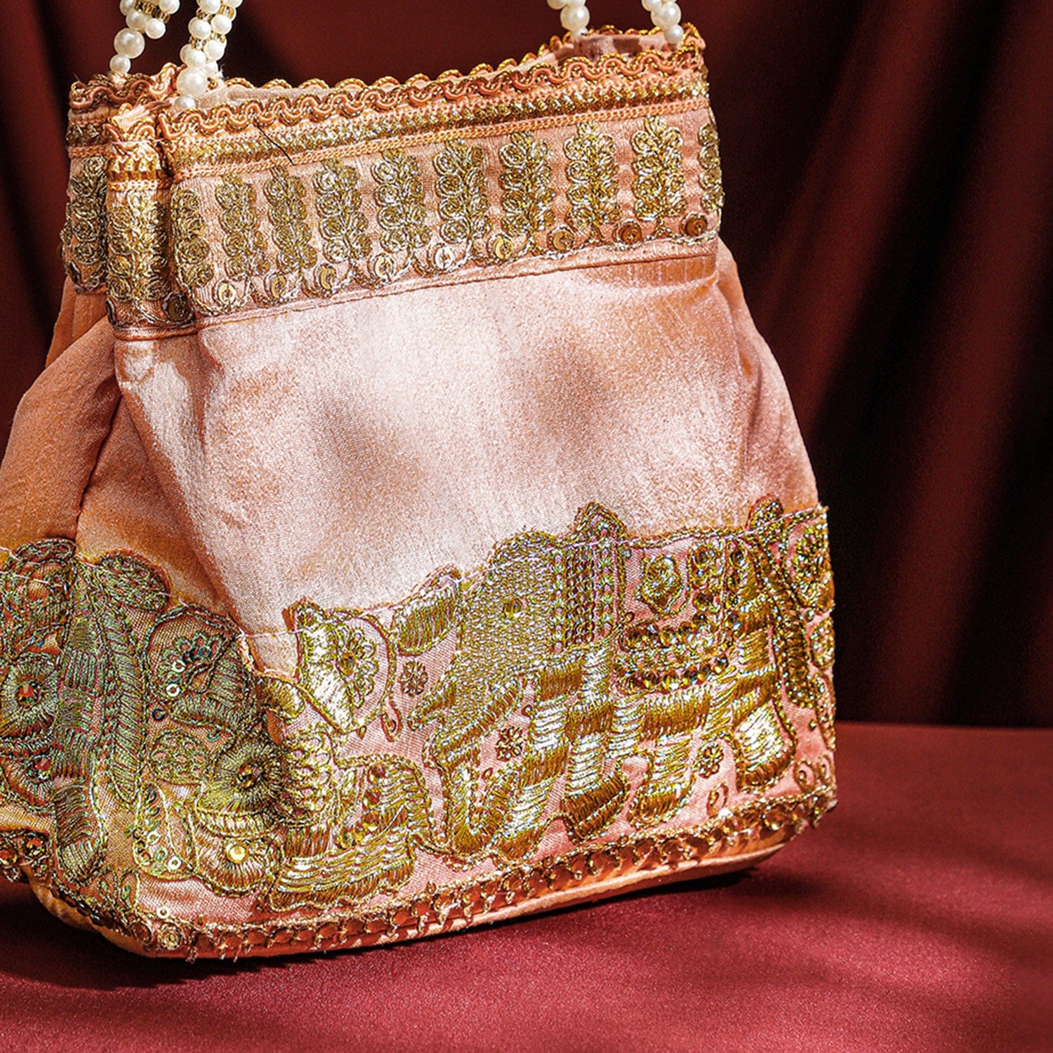 Wentra Handcrafted Peach Pink Silk Potli Bag with Pearl Handle & Gold Embroidered Elephant Motif