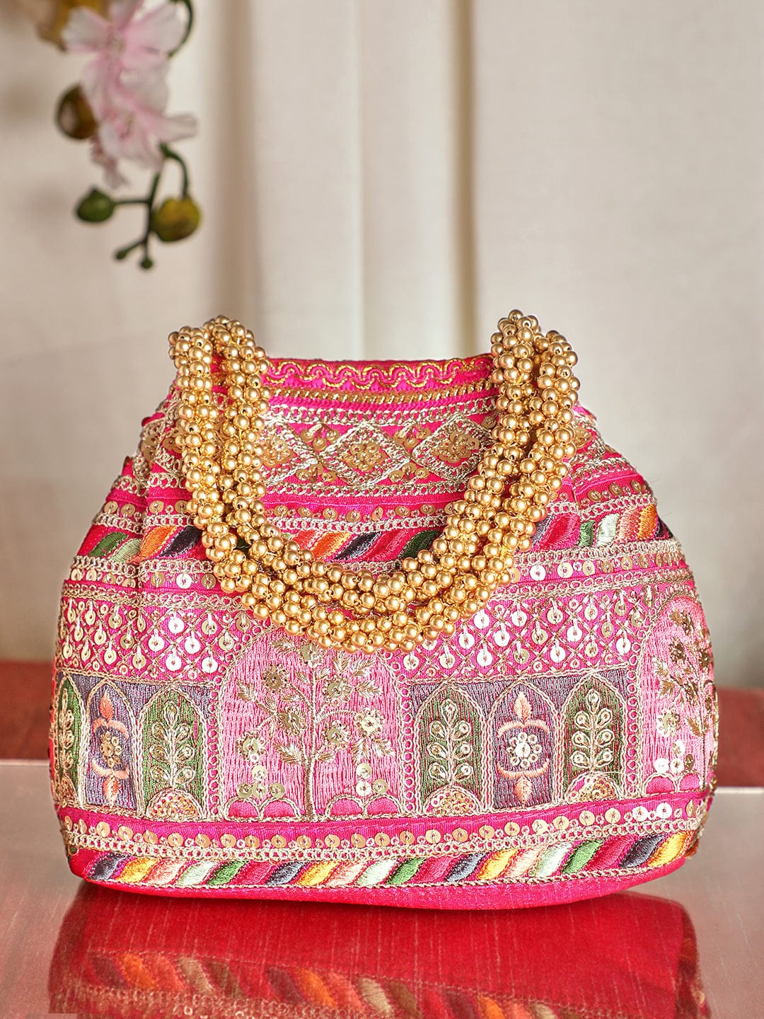 Wentra Pink Coloured Potli Bag With Multicoloured Embroidery Design